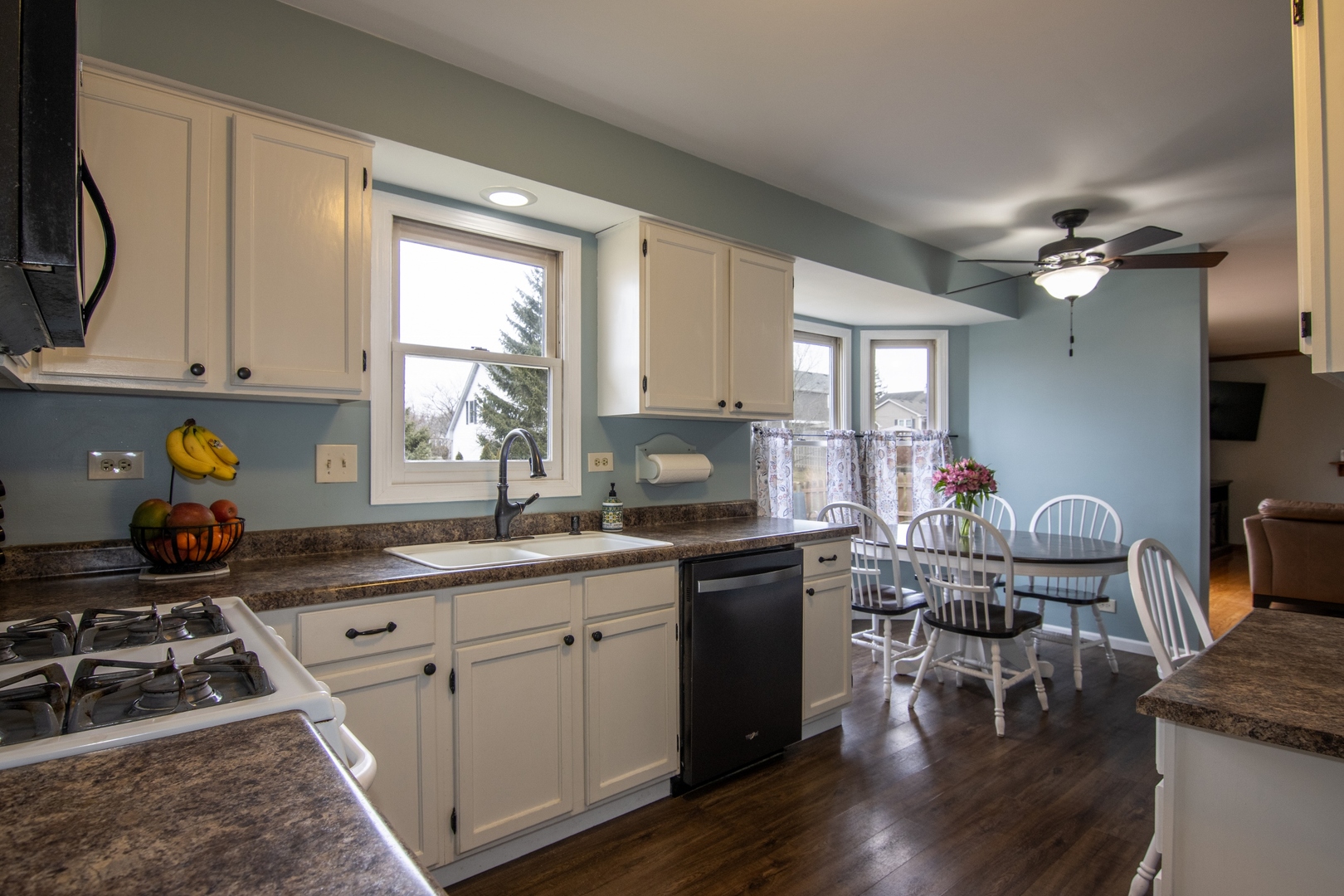 619 Chatham Circle Algonquin, IL 60102 - Photo 14 of 37 a kitchen with a stove a sink a dining table and chairs