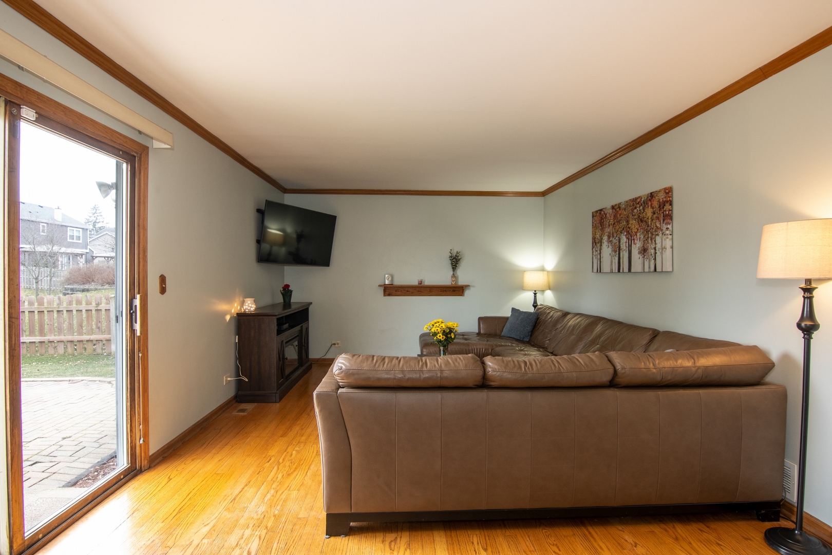 619 Chatham Circle Algonquin, IL 60102 - Photo 17 of 37 a living room with furniture a flat screen tv and a large window