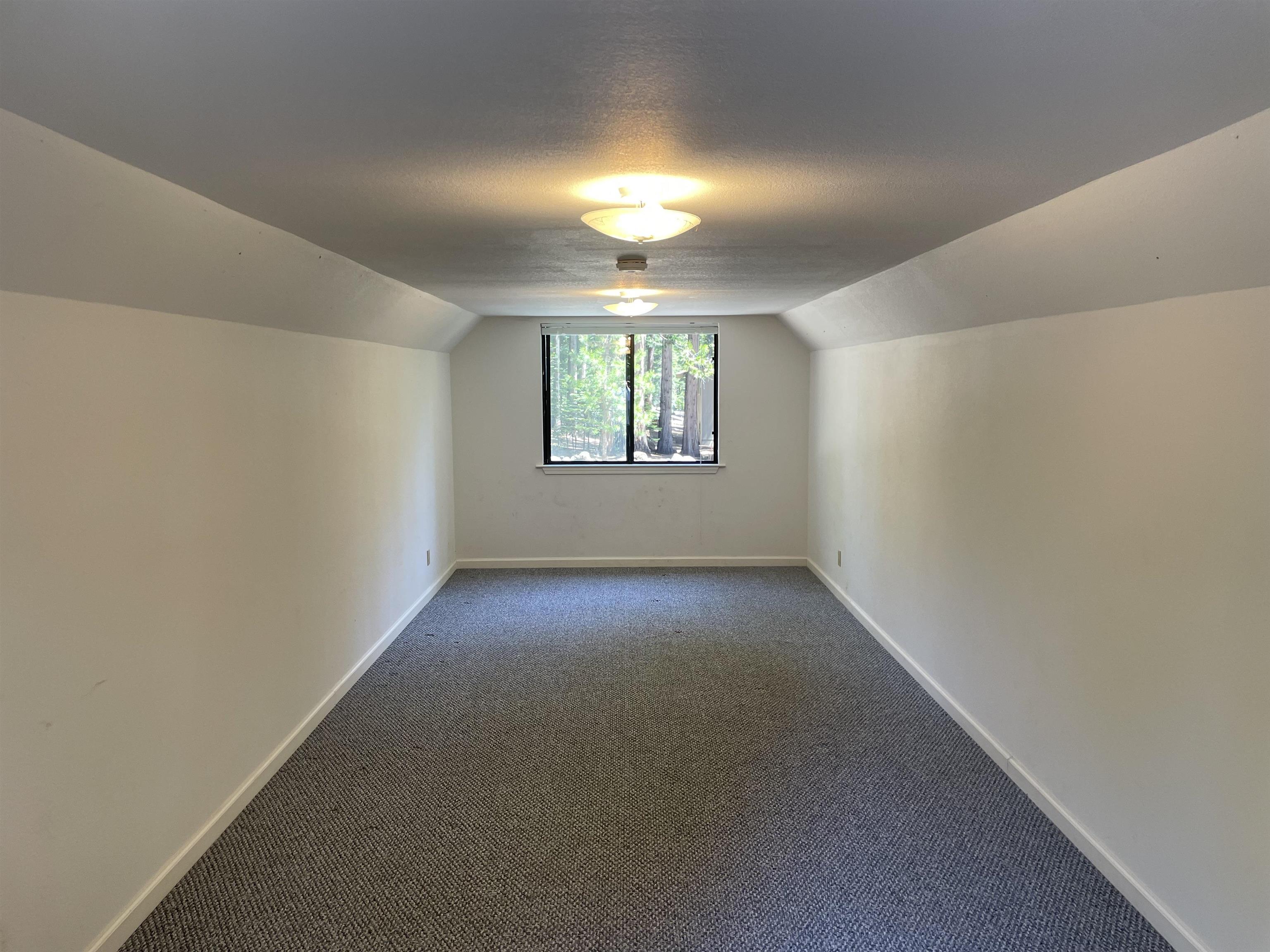 603 East Burnt Cedar Road Lake Almanor, CA 96137 - Photo 26 of 33 an empty room with windows & ceiling fan