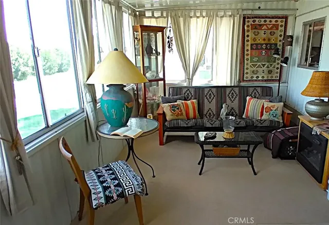 a living room with furniture and a floor to ceiling window