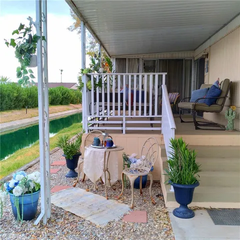 a view of a porch with furniture and garden