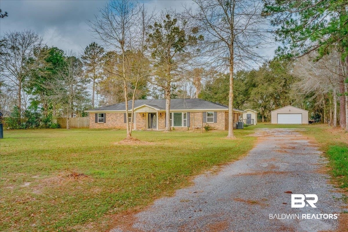 440 Dykes Road Mobile, AL 36608 - Photo 44 of 49 Ranch-style home with a front lawn, driveway, fence, an outdoor structure, and a garage