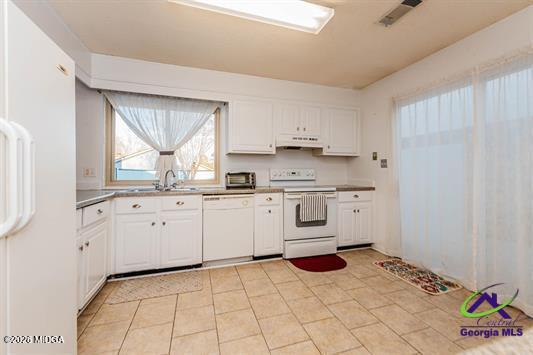 200 Atrium Court Warner Robins, GA 31088 - Photo 19 of 31 a kitchen with white cabinets and window