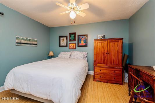200 Atrium Court Warner Robins, GA 31088 - Photo 22 of 31 a bedroom with a bed and a chandelier