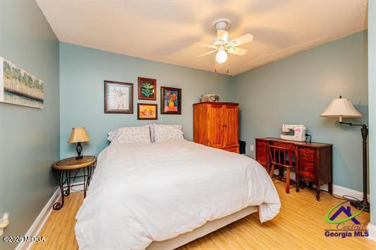 200 Atrium Court Warner Robins, GA 31088 - Photo 24 of 31 a bed room with a bed and a chandelier