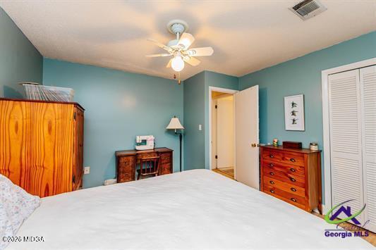 200 Atrium Court Warner Robins, GA 31088 - Photo 25 of 31 a bedroom with a bed and a chandelier