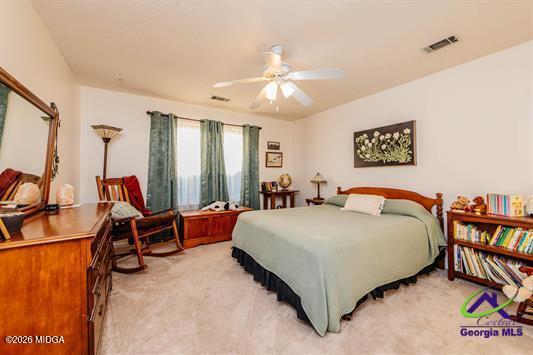 200 Atrium Court Warner Robins, GA 31088 - Photo 26 of 31 a bed room with a bed and a book shelf
