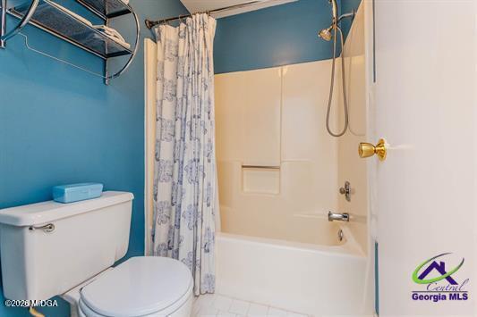 200 Atrium Court Warner Robins, GA 31088 - Photo 5 of 31 a white toilet sitting next to a bath tub and shower