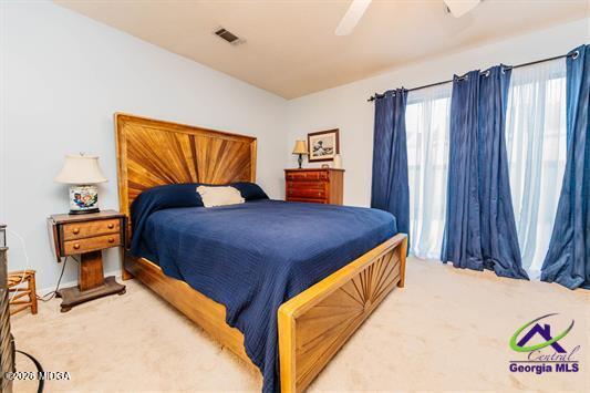 200 Atrium Court Warner Robins, GA 31088 - Photo 10 of 31 a bedroom with a bed and a painting on the wall