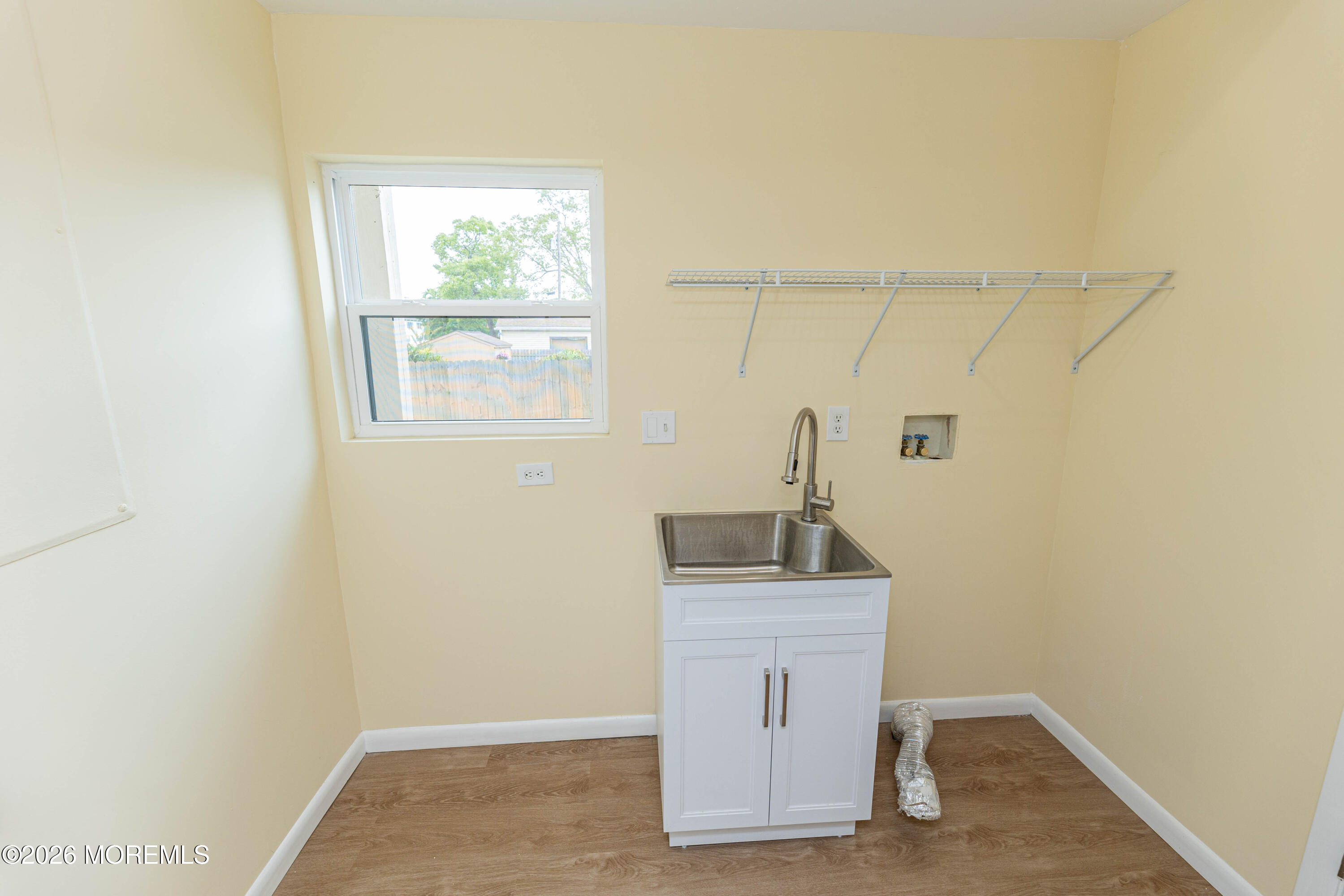 2408 Herbertsville Road Point Pleasant, NJ 08742 - Photo 66 of 82 a bathroom with a sink a window and mirror