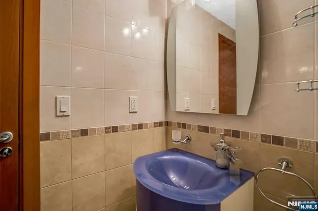 a bathroom with a sink a toilet and mirror