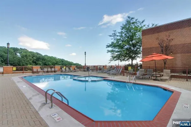 a view of a swimming pool with chairs in patio