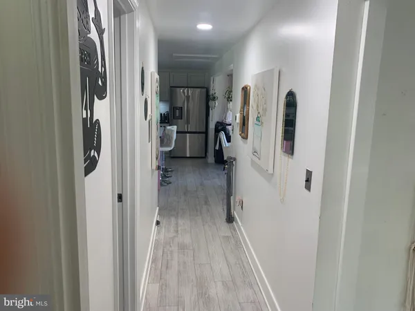 a bedroom with a bed and a large mirror on the dresser