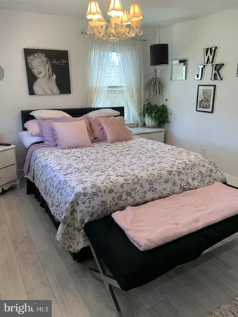 a room with a table chairs and a clock on the wall