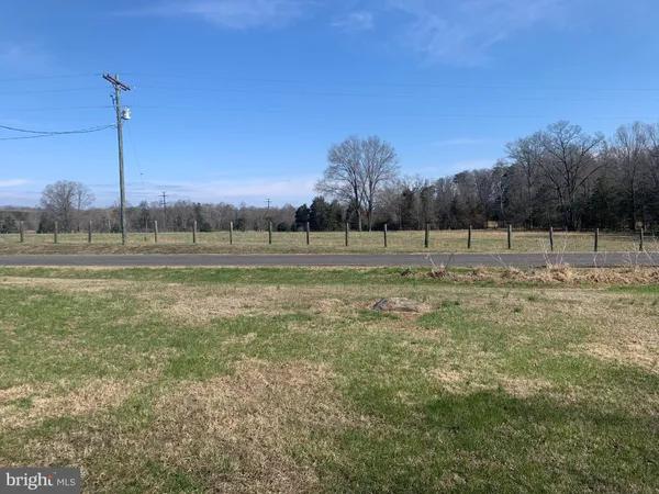 a view of a backyard with wooden fence
