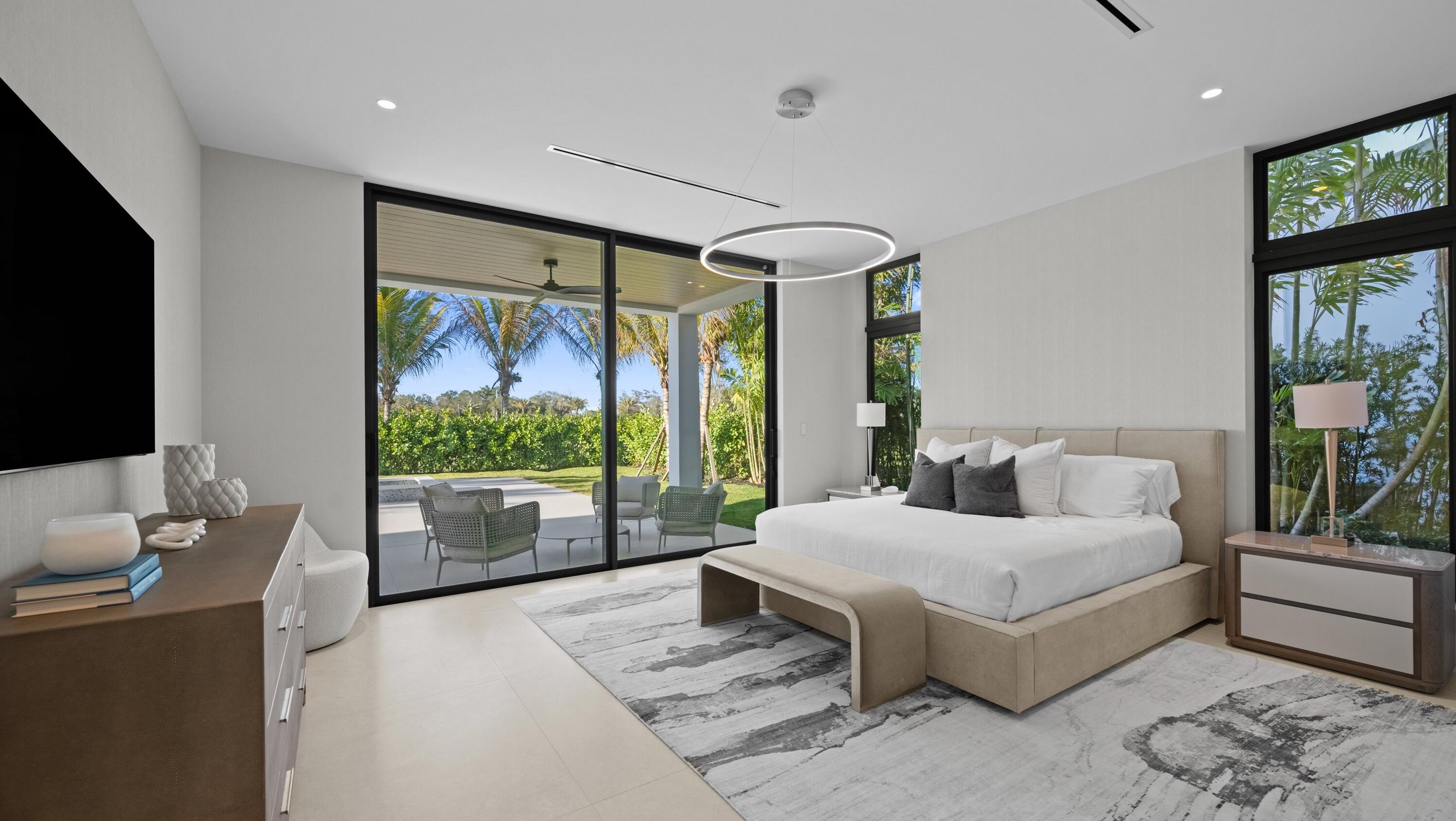 11368 Polo Park Trail Wellington, FL 33414 - Photo 11 of 33 a spacious bedroom with a large bed and a flat tv screen