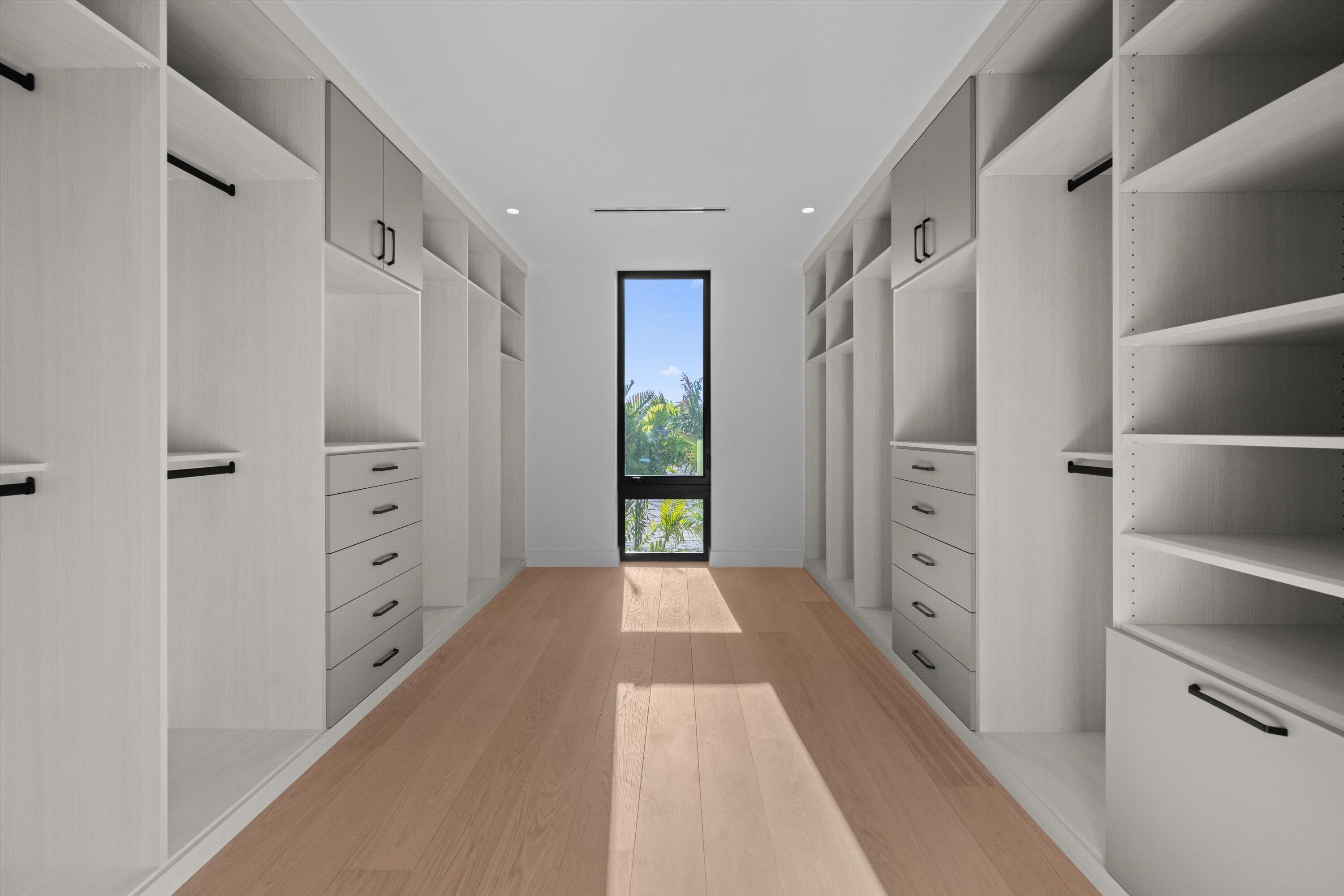 11368 Polo Park Trail Wellington, FL 33414 - Photo 18 of 33 a hallway with closet and a large window