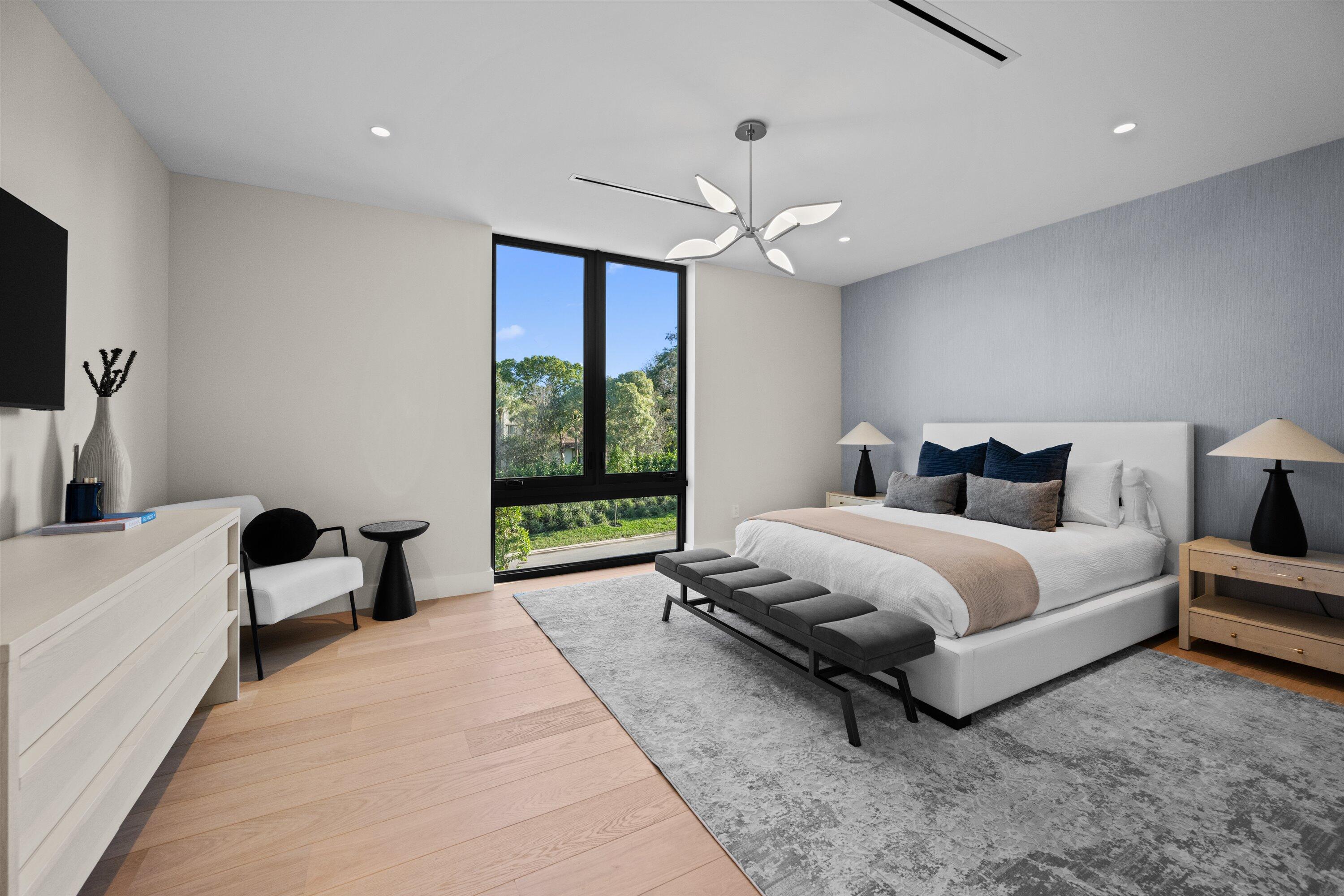 11368 Polo Park Trail Wellington, FL 33414 - Photo 22 of 33 a spacious bedroom with a bed and large windows