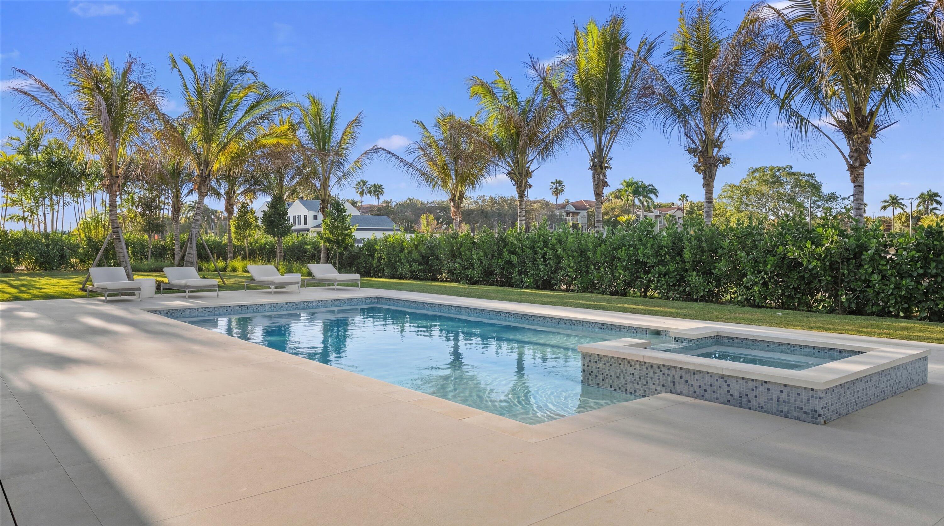 11368 Polo Park Trail Wellington, FL 33414 - Photo 32 of 33 a view of a swimming pool with a lawn chairs and palm tree