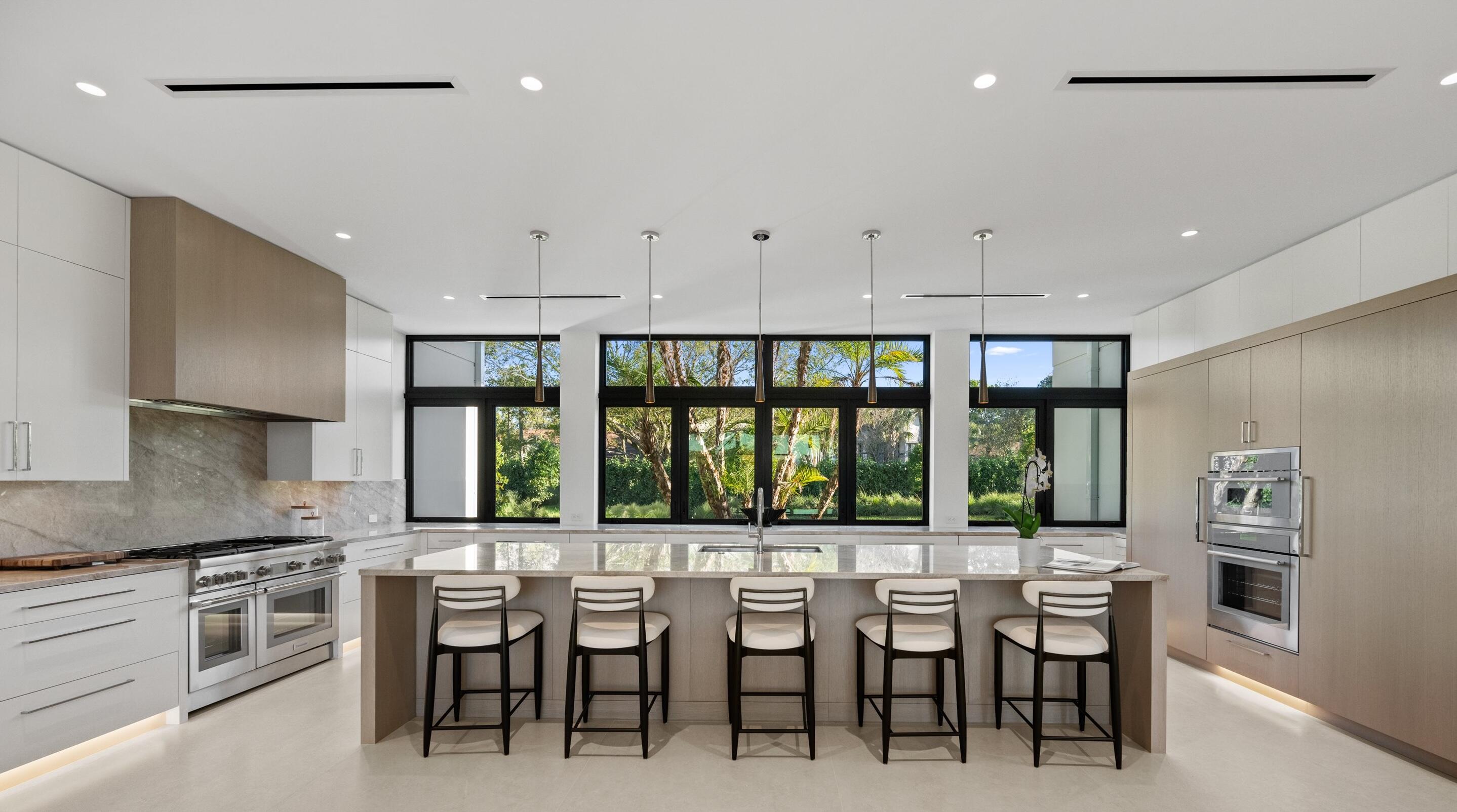 11368 Polo Park Trail Wellington, FL 33414 - Photo 5 of 33 a kitchen with lots of counter and chairs