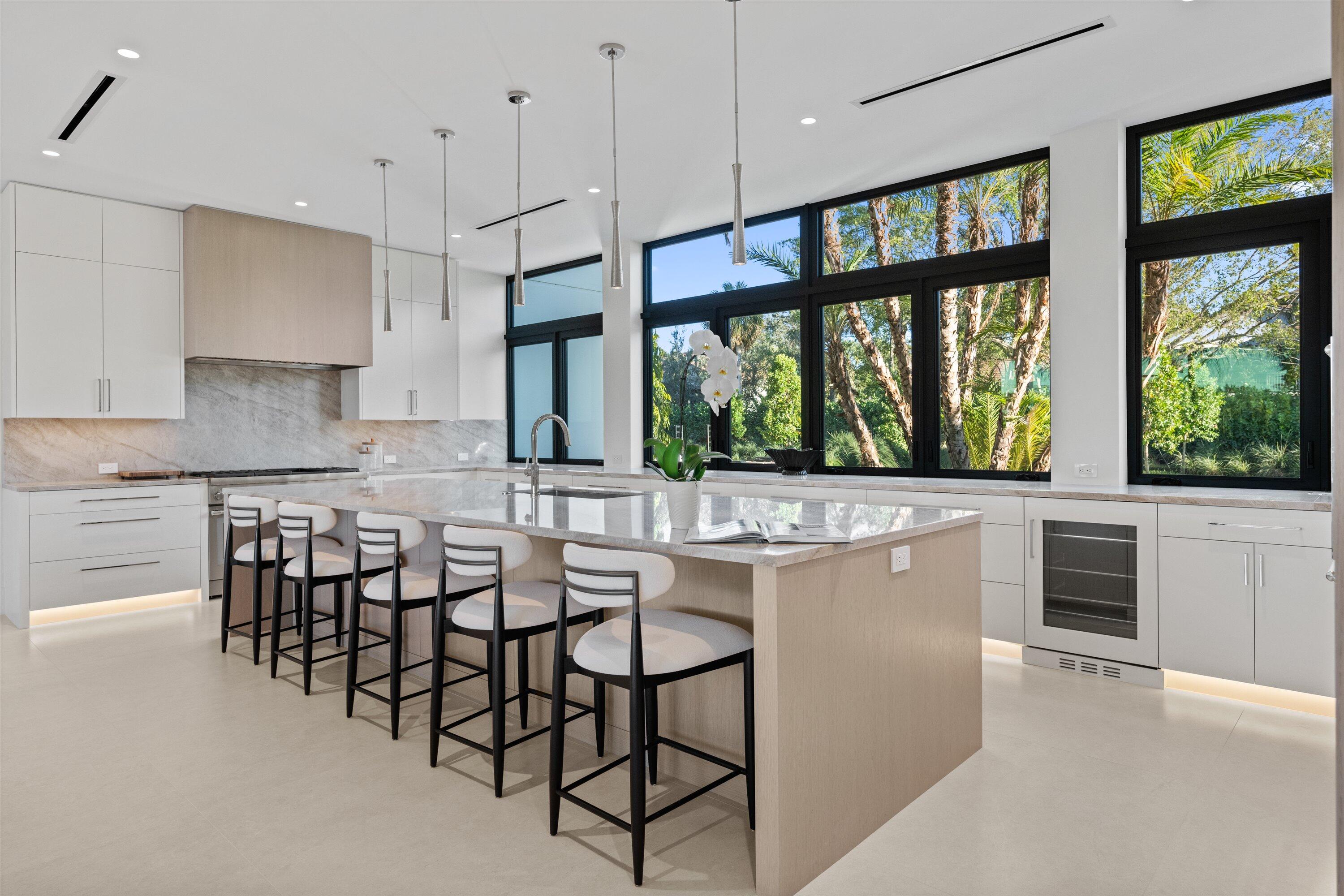 11368 Polo Park Trail Wellington, FL 33414 - Photo 6 of 33 a kitchen with large window and wooden floor