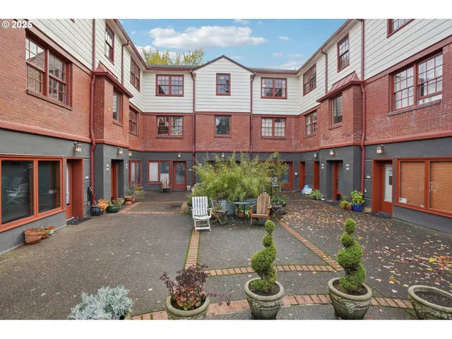 a front view of a brick building with many windows