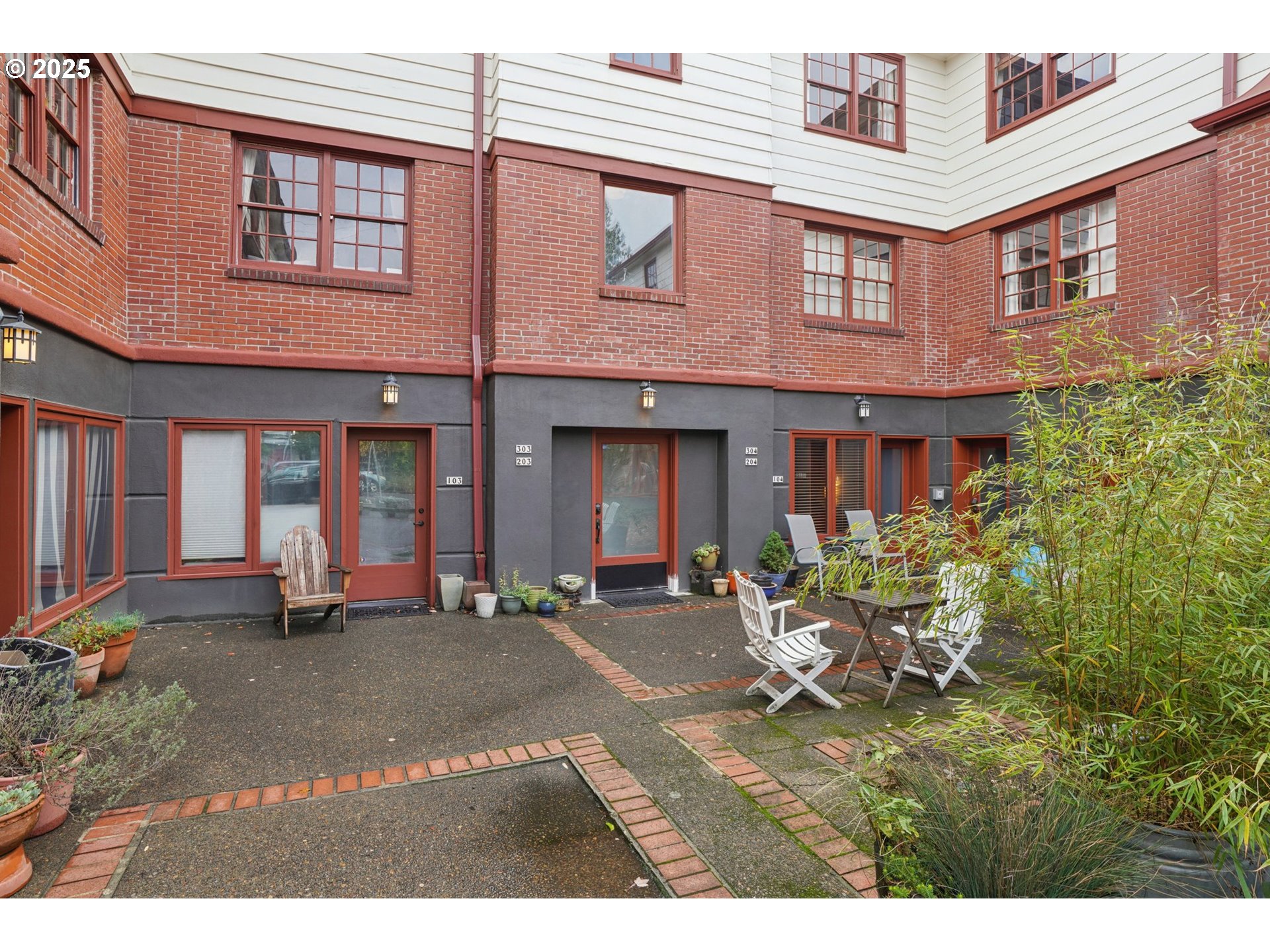 5400 Northeast 30th Avenue, Unit 304 Portland, OR 97211 - Photo 2 of 15 a front view of a brick house with many windows