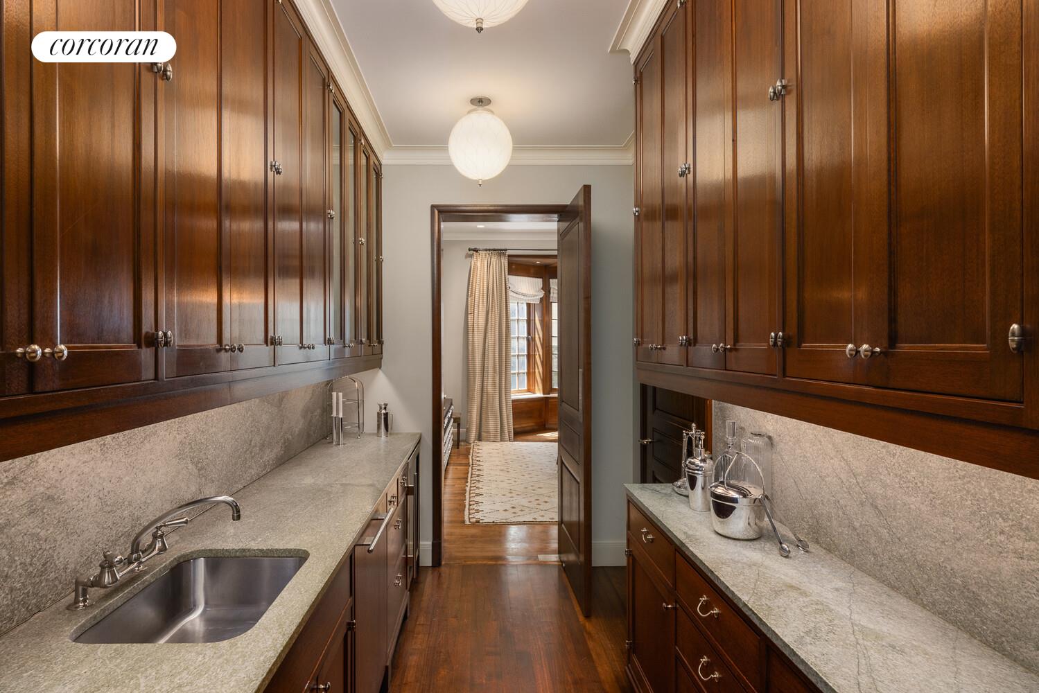 4 East 73rd Street Manhattan, NY 10021 - Photo 15 of 32 a kitchen with stainless steel appliances sink a stove and cabinets
