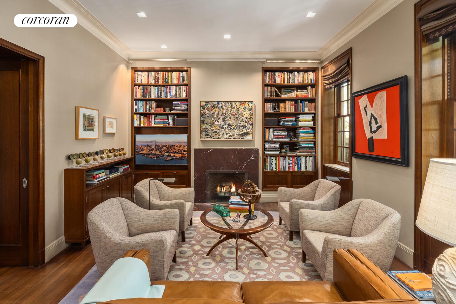 4 East 73rd Street Manhattan, NY 10021 - Photo 18 of 32 a living room with furniture a rug and a bookshelf