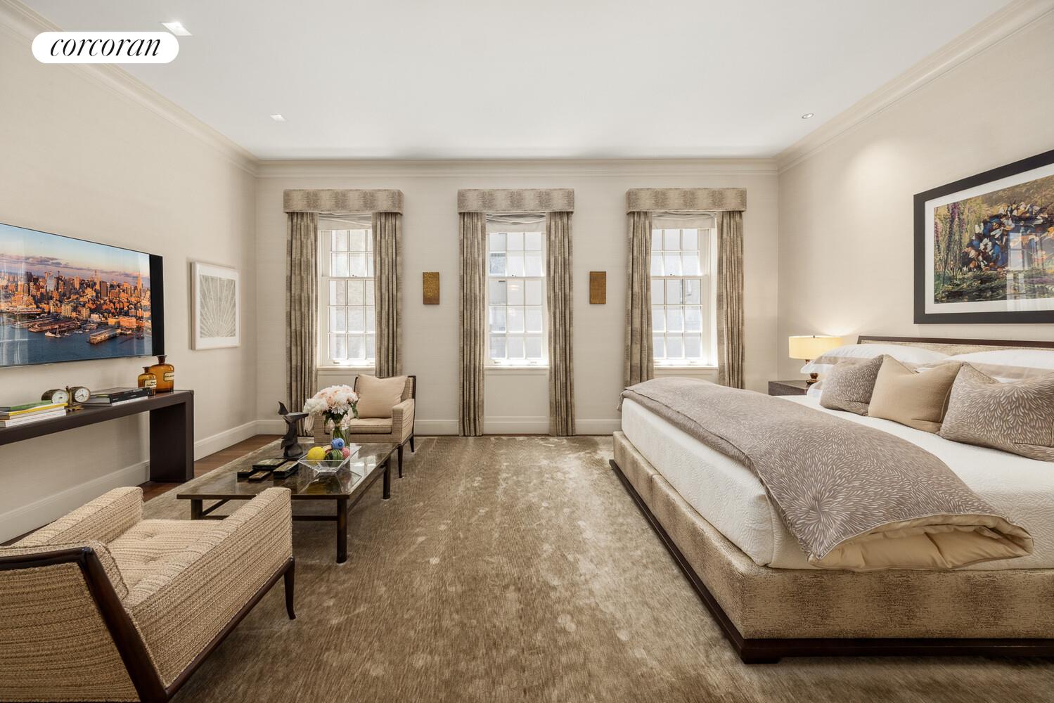 4 East 73rd Street Manhattan, NY 10021 - Photo 19 of 32 a spacious bedroom with a bed and glass windows