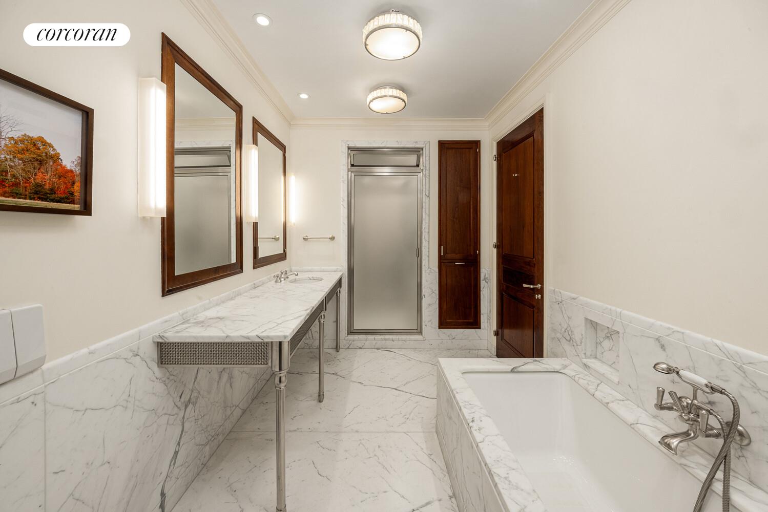 4 East 73rd Street Manhattan, NY 10021 - Photo 20 of 32 a bathroom with a tub sink and mirror