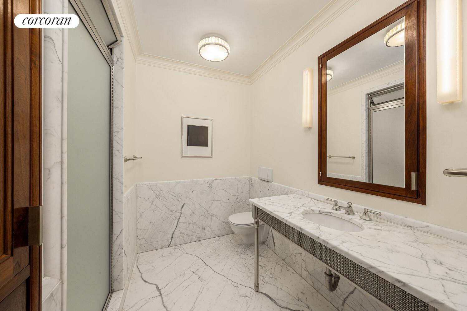 4 East 73rd Street Manhattan, NY 10021 - Photo 21 of 32 a bathroom with a sink and a mirror