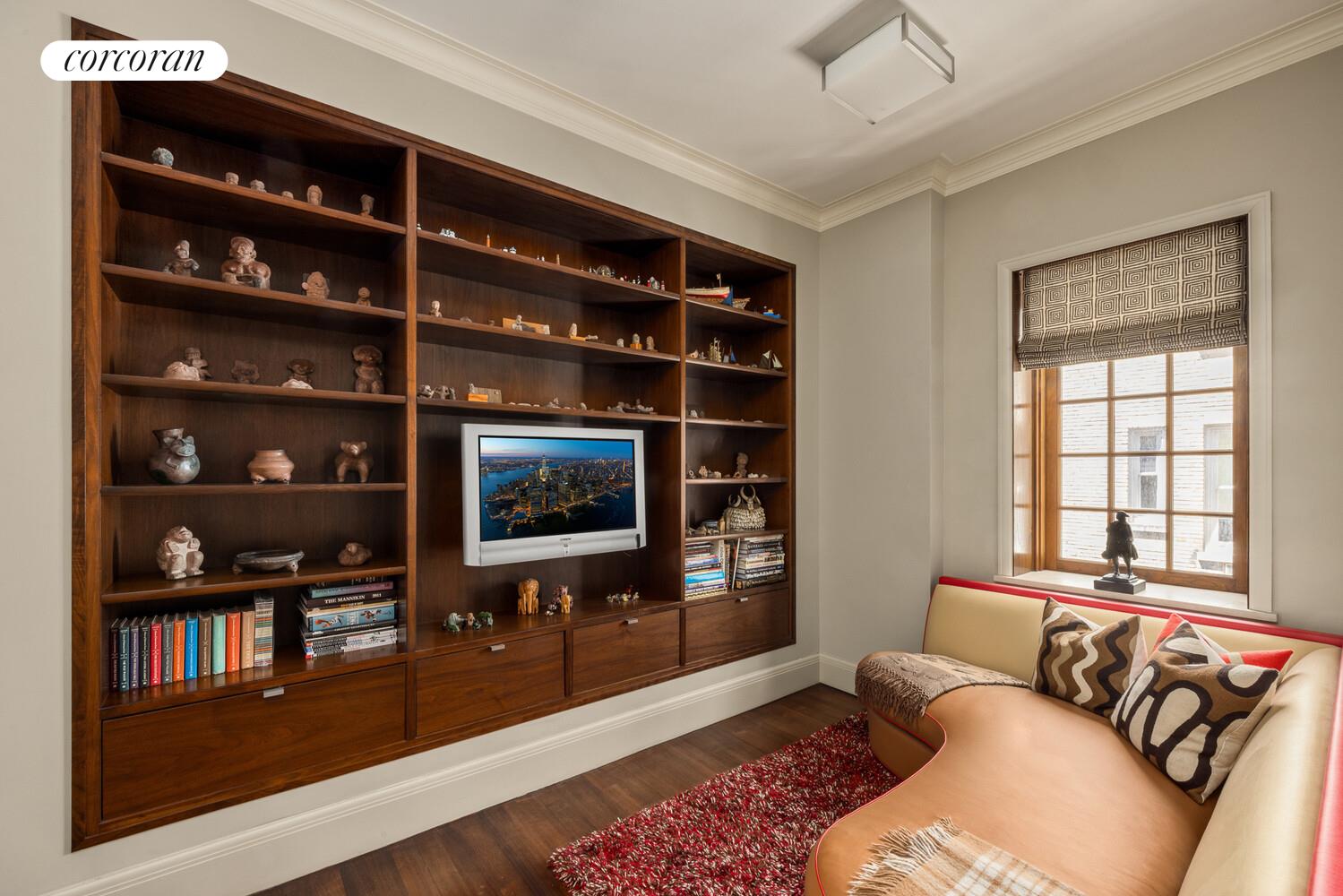 4 East 73rd Street Manhattan, NY 10021 - Photo 27 of 32 a living room with furniture and a flat screen tv