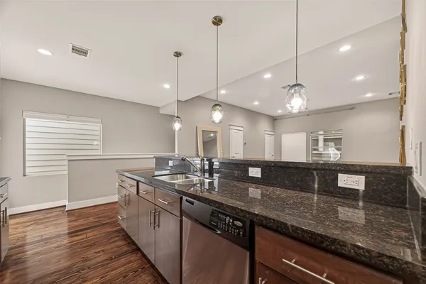 a kitchen with lots of counter space a sink and appliances