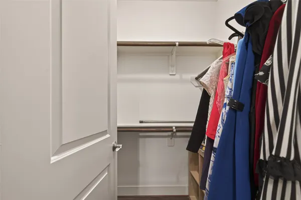a view of walk in closet with clothes