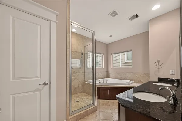 a bathroom with a sink double vanity and a shower