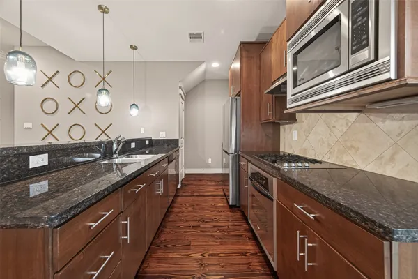 a large kitchen with a stove and a sink
