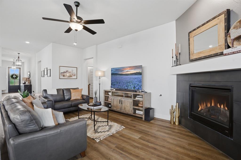 1632 Cotton Road Van Alstyne, TX 75495 - Photo 6 of 40 a living room with furniture a fireplace and a ceiling fan