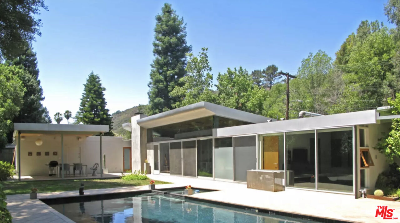 a backyard of a house with yard and outdoor seating
