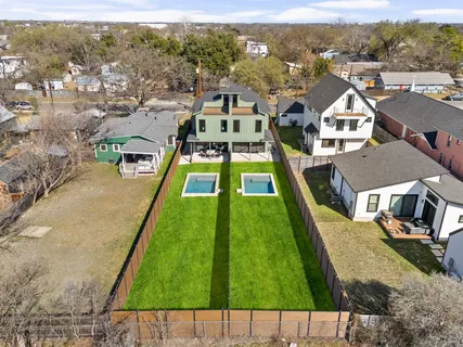 a front view of a house with swimming pool having outdoor seating
