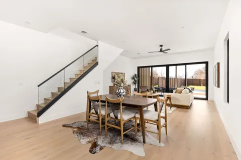 a kitchen with a table chairs stove and kitchen view