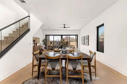 a kitchen with stainless steel appliances granite countertop a sink a stove and a wooden floor