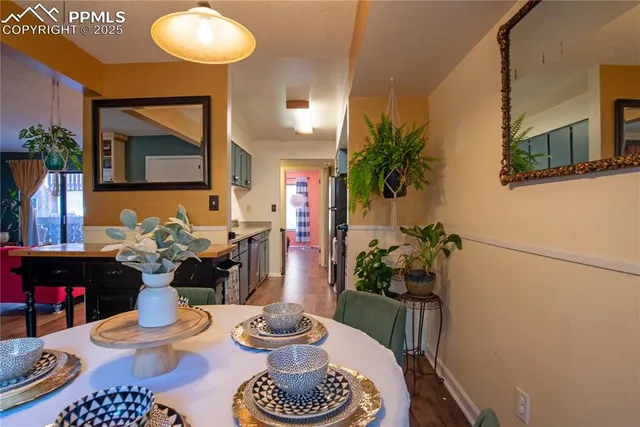 a dining room with furniture and wooden floor