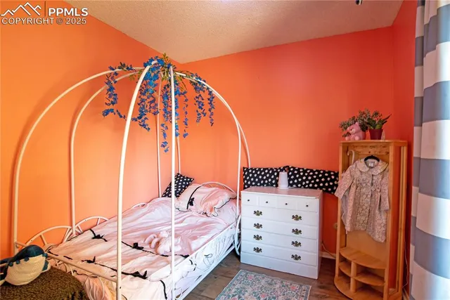 a view of a bedroom with a bed and wooden cabinets