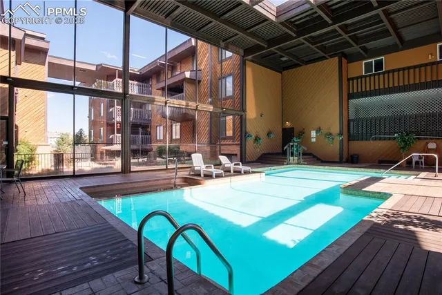 a swimming pool with outdoor seating and yard