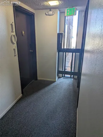 a view of a livingroom with furniture and staircase