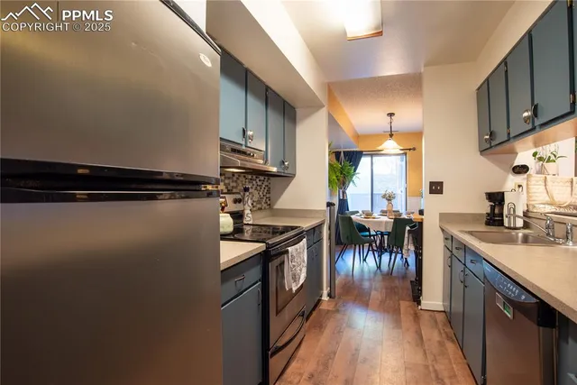 a kitchen with sink cabinets and a stove top oven