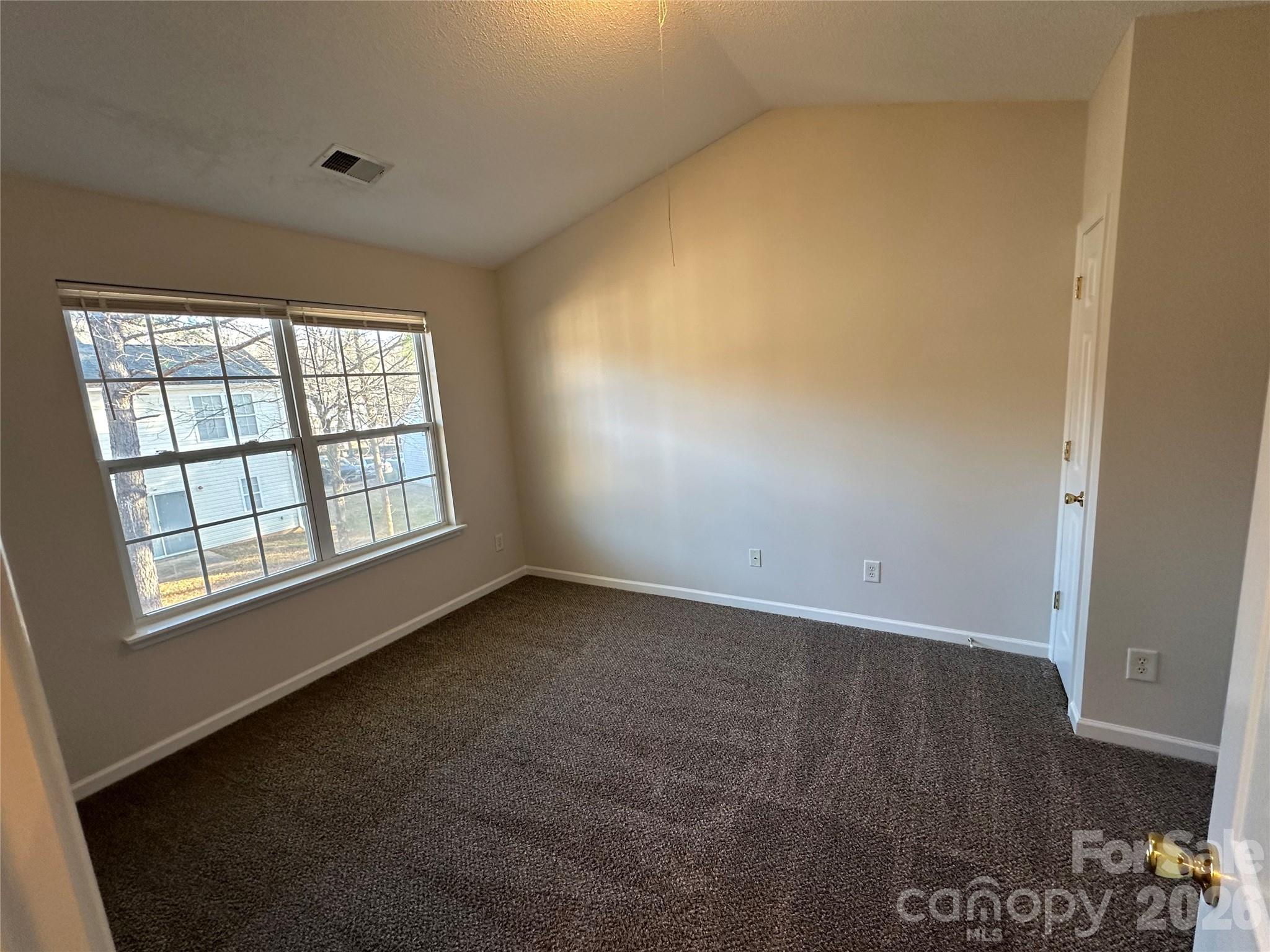 5227 Magnolia Tree Lane Charlotte, NC 28215 - Photo 12 of 20 an empty room with wooden floor and windows