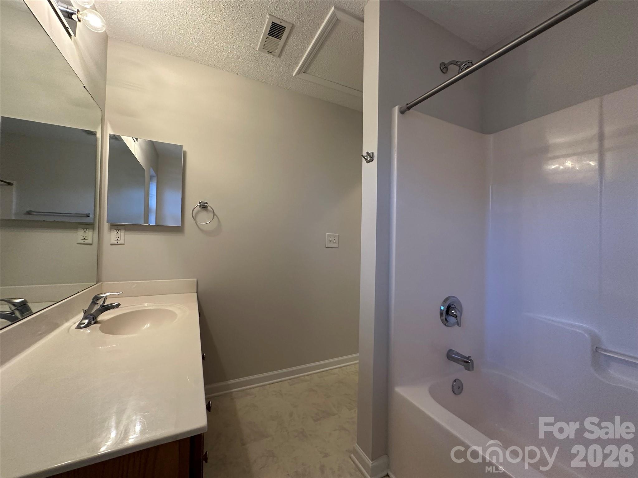 5227 Magnolia Tree Lane Charlotte, NC 28215 - Photo 14 of 20 a bathroom with a sink and shower