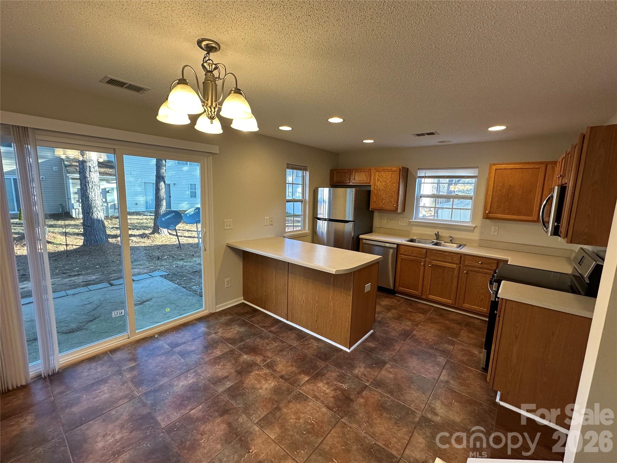5227 Magnolia Tree Lane Charlotte, NC 28215 - Photo 3 of 20 a large kitchen with a large window and stainless steel appliances